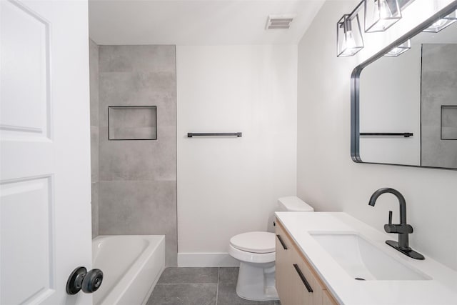 full bathroom featuring vanity, tiled shower / bath, tile patterned flooring, and toilet