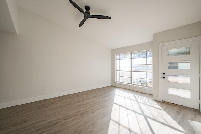 foyer entrance with lofted ceiling, wood-type flooring, and ceiling fan