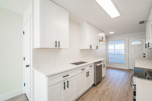 kitchen with white cabinetry, dishwasher, range, and light hardwood / wood-style floors