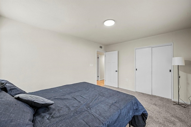 carpeted bedroom with a closet