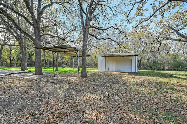 view of yard with a garage and an outdoor structure