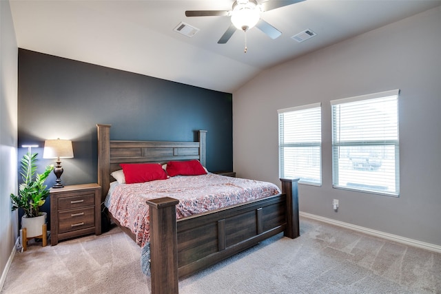 bedroom with vaulted ceiling, light colored carpet, and ceiling fan