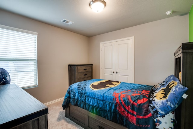 carpeted bedroom featuring a closet