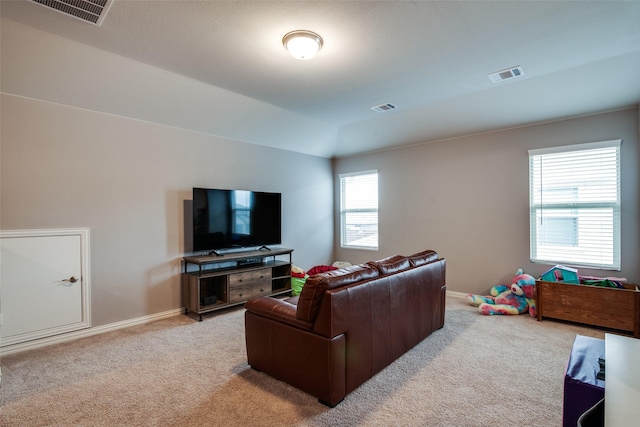 living room featuring vaulted ceiling and light colored carpet