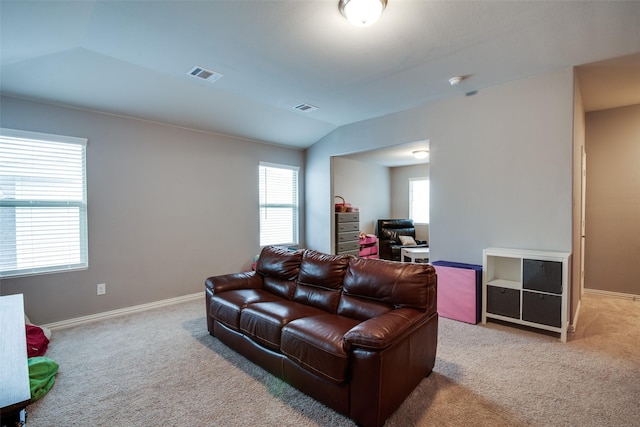 living room featuring lofted ceiling and light carpet