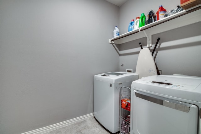 washroom with separate washer and dryer and light tile patterned floors