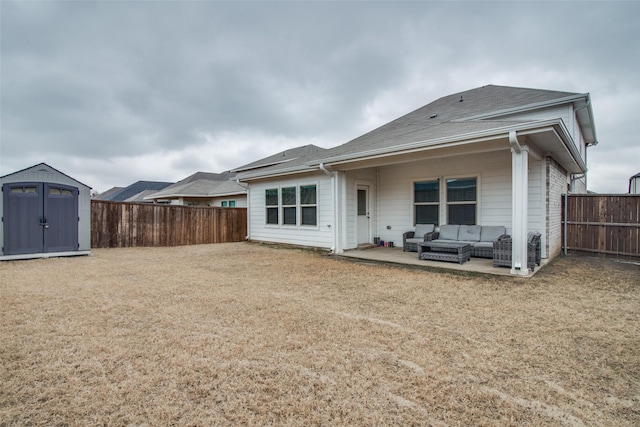 rear view of property featuring a storage shed, an outdoor hangout area, and a patio area