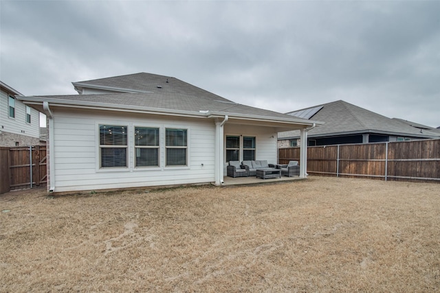 rear view of property with a yard, a patio area, and outdoor lounge area