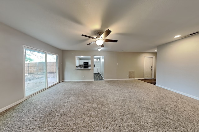 unfurnished living room with ceiling fan and carpet flooring