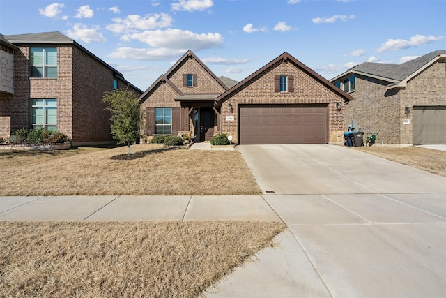 view of front facade with brick siding, an attached garage, and concrete driveway