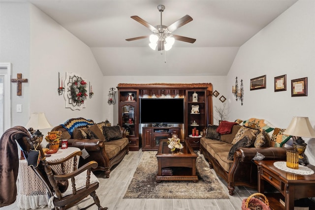 living area with ceiling fan, lofted ceiling, and wood finish floors