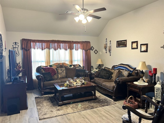 living room with lofted ceiling, a ceiling fan, and light wood-type flooring