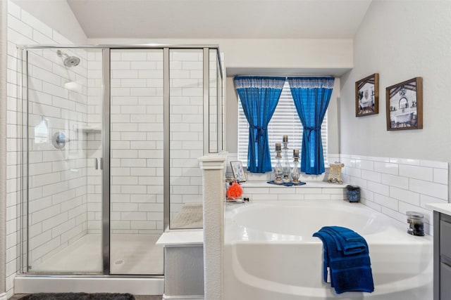 full bathroom with a shower stall and a garden tub