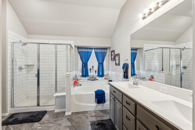 bathroom with a bath, a shower stall, lofted ceiling, and a sink