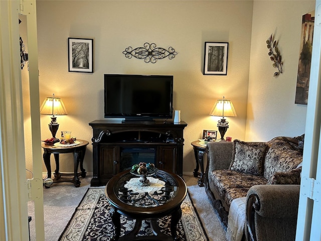 carpeted living room featuring baseboards