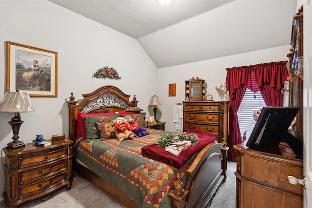 carpeted bedroom featuring lofted ceiling