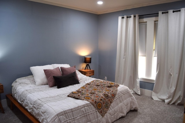 bedroom with ornamental molding and carpet flooring