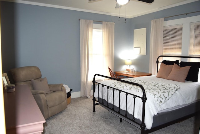 bedroom featuring crown molding, light colored carpet, and ceiling fan