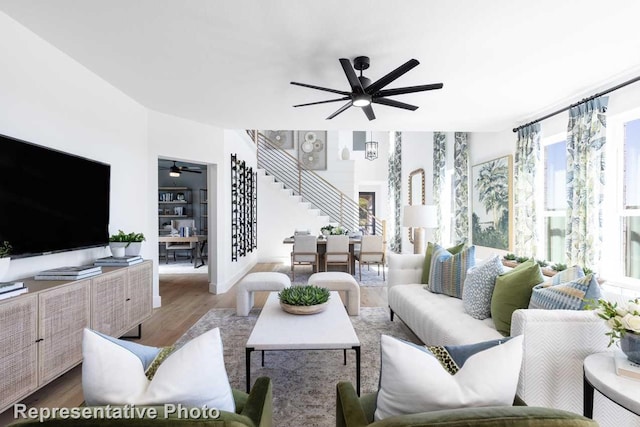 living room featuring hardwood / wood-style flooring and ceiling fan