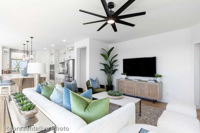 living room featuring light hardwood / wood-style floors and ceiling fan