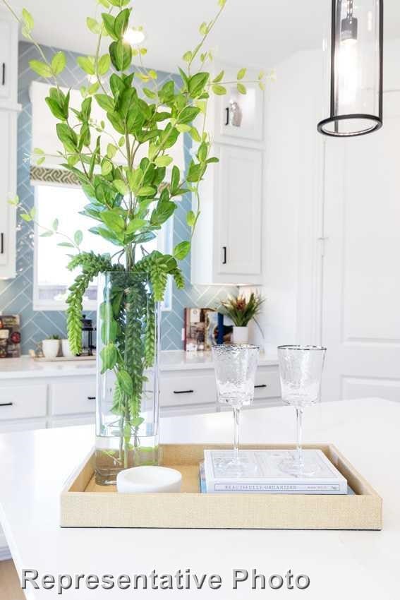 bar featuring white cabinetry and backsplash