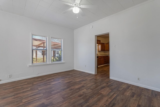 empty room featuring ceiling fan, ornamental molding, and dark hardwood / wood-style flooring