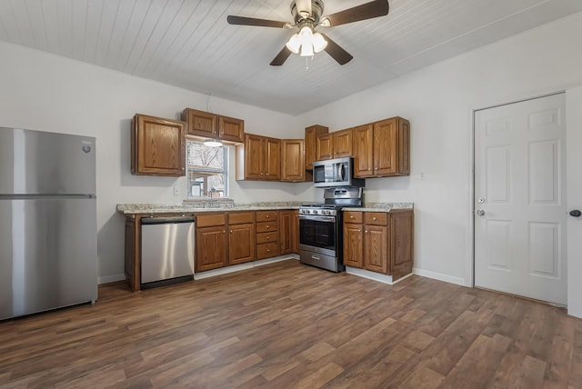 kitchen featuring dark hardwood / wood-style floors, sink, wood ceiling, ceiling fan, and stainless steel appliances