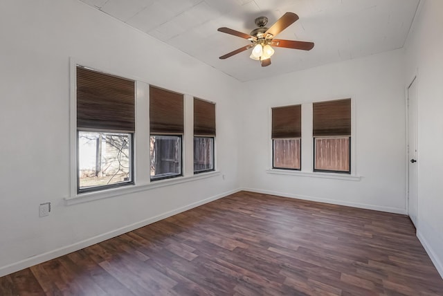 spare room with ceiling fan and dark hardwood / wood-style floors