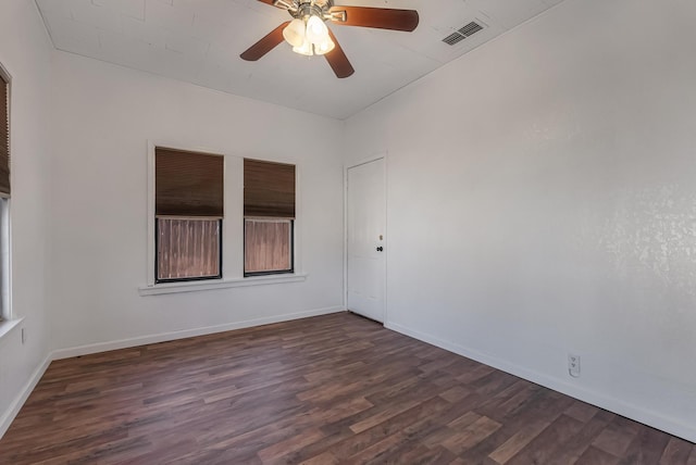 empty room with ceiling fan and dark hardwood / wood-style floors