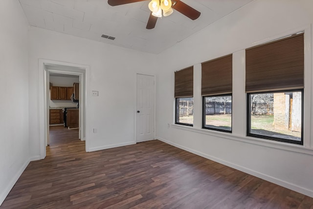 spare room with dark hardwood / wood-style floors and ceiling fan