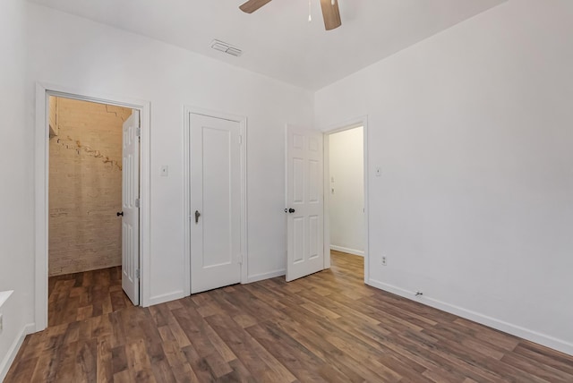 unfurnished bedroom featuring dark hardwood / wood-style flooring and ceiling fan