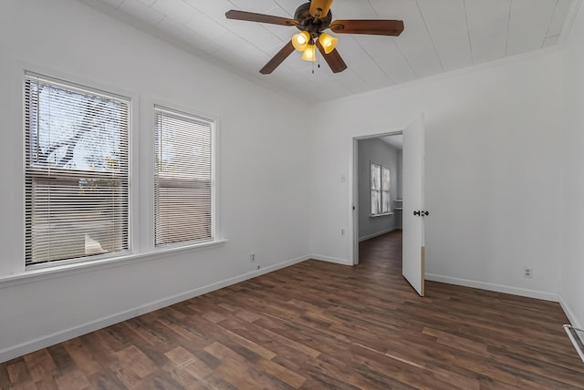 unfurnished room with crown molding, plenty of natural light, dark wood-type flooring, and ceiling fan