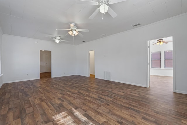 empty room with crown molding and dark hardwood / wood-style floors