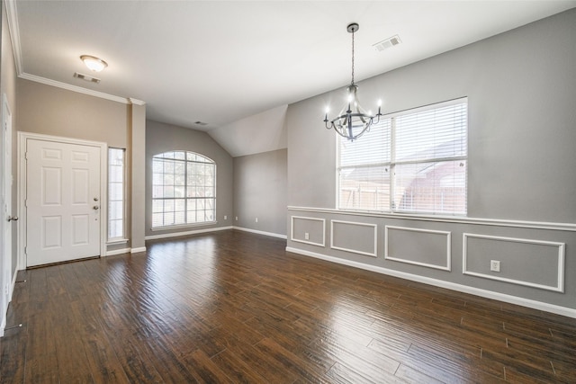 unfurnished dining area featuring an inviting chandelier, ornamental molding, lofted ceiling, and dark hardwood / wood-style flooring