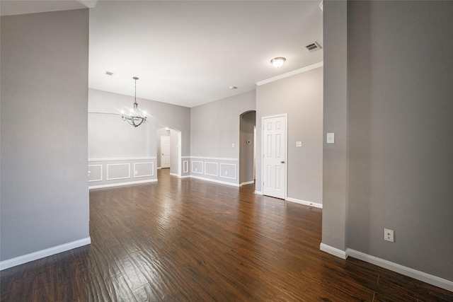 unfurnished living room with dark hardwood / wood-style flooring and a chandelier