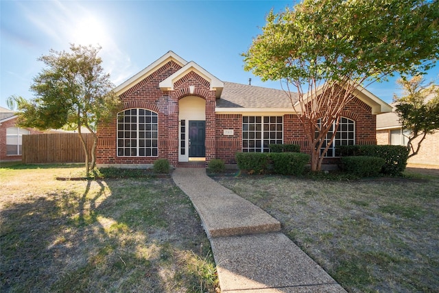 ranch-style home featuring a front yard