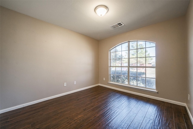 empty room featuring dark hardwood / wood-style flooring