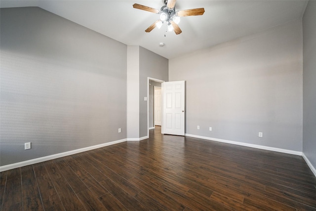 empty room with vaulted ceiling, dark wood-type flooring, and ceiling fan