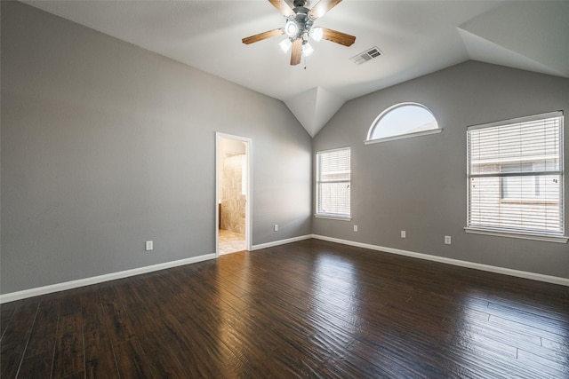 empty room with lofted ceiling, dark hardwood / wood-style floors, and ceiling fan