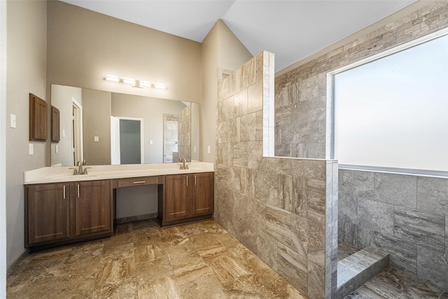 bathroom featuring vanity and tiled shower