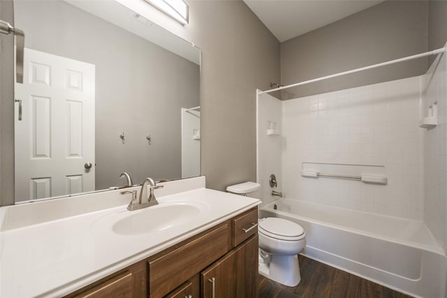 full bathroom with vanity, hardwood / wood-style flooring, toilet, and washtub / shower combination