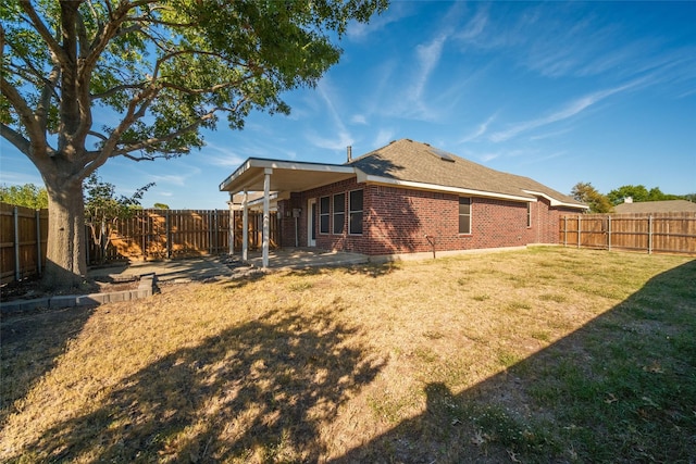 rear view of house with a lawn