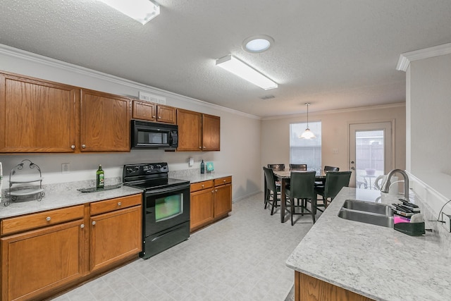 kitchen with pendant lighting, ornamental molding, sink, and black appliances