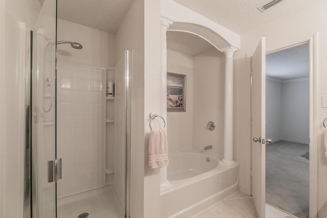 bathroom with ornate columns, separate shower and tub, and a textured ceiling