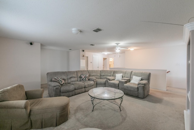 living room featuring light colored carpet and a textured ceiling