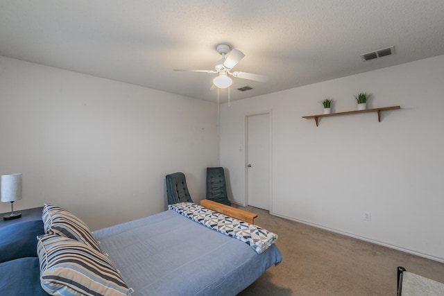 bedroom featuring carpet, a textured ceiling, and ceiling fan