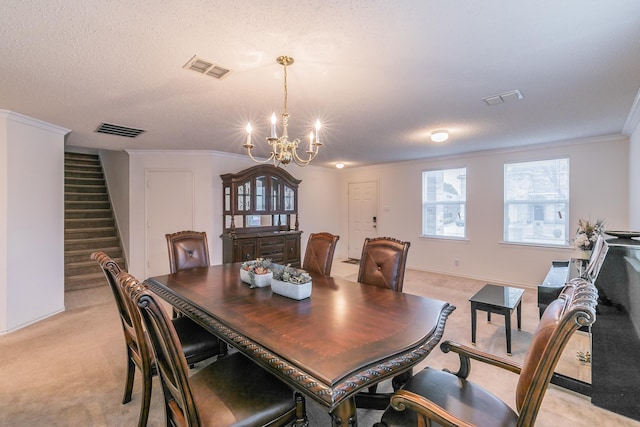 dining area featuring light carpet, a notable chandelier, crown molding, and a textured ceiling