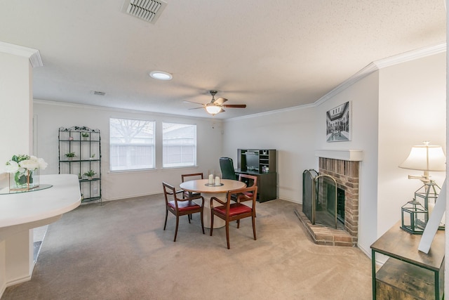 carpeted dining space featuring a brick fireplace, ornamental molding, and ceiling fan