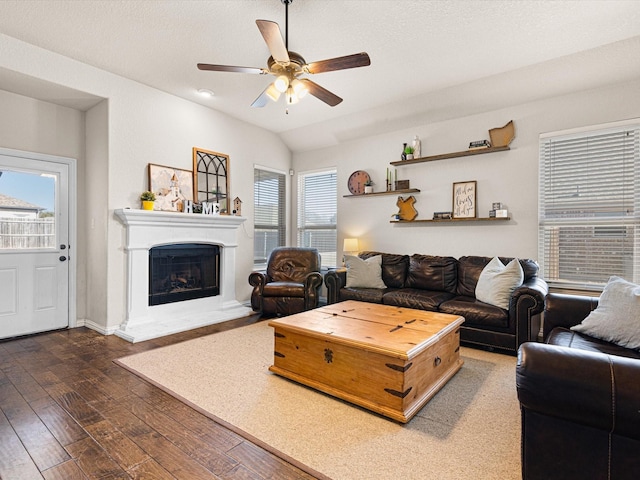 living room featuring lofted ceiling, plenty of natural light, dark hardwood / wood-style floors, and ceiling fan