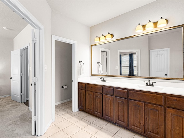 bathroom with tile patterned floors and vanity